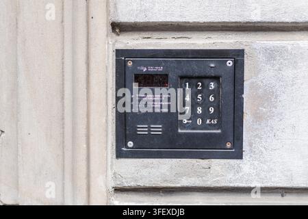 Black Intercom Keypad on Weathered Building Wall in Warsaw Stock Photo
