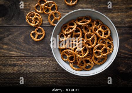 Oktoberfest Pretzel mini crunchy snacks in bowl on dark rustic wooden background table Stock Photo