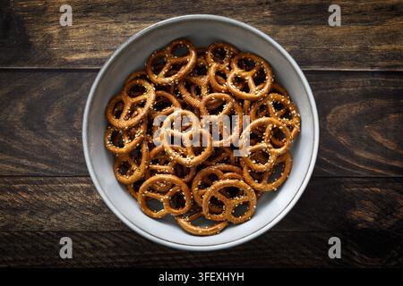 Oktoberfest Pretzel mini crunchy snacks in bowl on dark rustic wooden background table Stock Photo