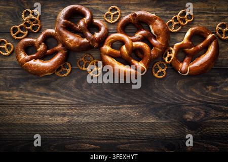 Oktoberfest Pretzel bavarian soft baked brezel and mini snacks on dark wooden background Stock Photo