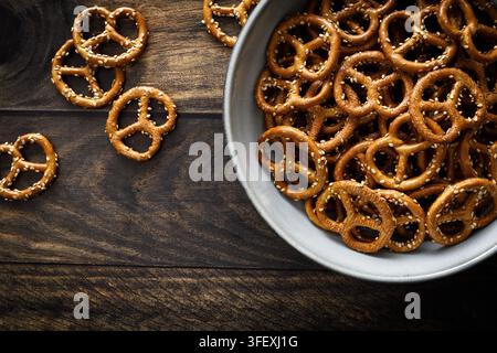 Oktoberfest Pretzel mini crunchy snacks in bowl on dark rustic wooden background table Stock Photo
