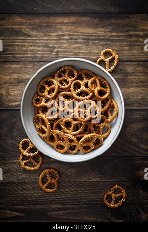 Oktoberfest Pretzel mini crunchy snacks in bowl on dark rustic wooden background table Stock Photo