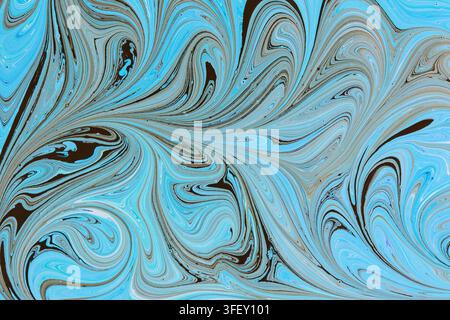 Intricate ebru marble pattern featuring light blue paint swirls contrasted with deep brown fluid lines Stock Photo