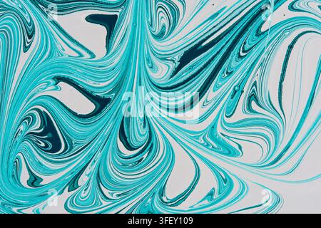 Abstract ebru paint art with turquoise and dark blue swirling marble patterns on white background Stock Photo