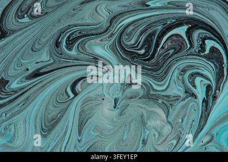 Abstract fluid art marble background with swirl patterns turquoise blue black paint mixture Stock Photo