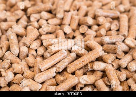 Wooden cat litter, top view. Hygienic litter for pets. Wood pellet cat litter as a background, close-up. Pressed wood, large granules. Pellets. Pile of wood pellets. Stock Photo