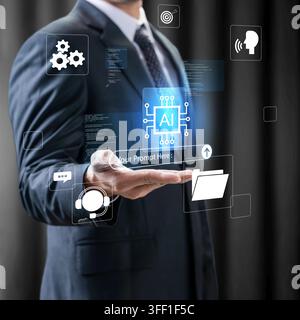 A businessman in a suit holds a glowing virtual interface showing an AI chip, prompt input, and technological icons on a dark background Stock Photo