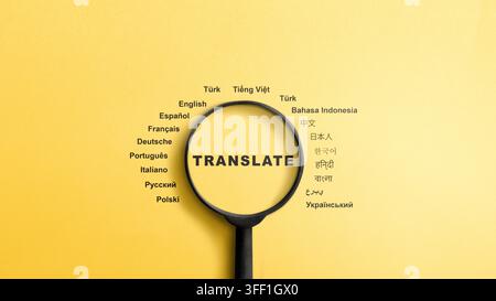 A top-down view of a black magnifying glass focusing on the word translate, surrounded by names of different languages written in their native scripts Stock Photo