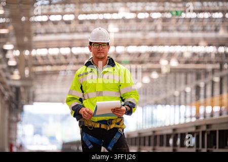 Engineer railway under inspection and checking construction railway switch and checking work on railroad station. Stock Photo