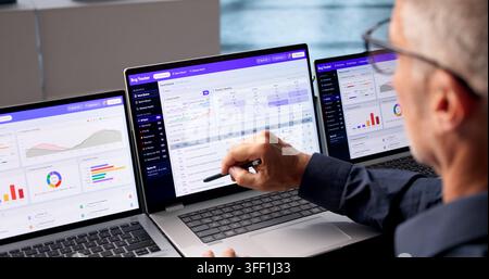 Software Developer Reviews Bug Tracking Dashboard To Prioritize Issue Resolution Tasks. Stock Photo