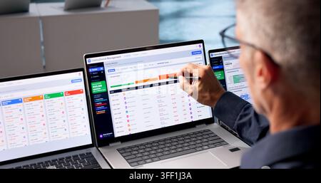 Revenue Cycle Manager Reviews Patient Claims Data On Laptop For Denial Appeals. Stock Photo