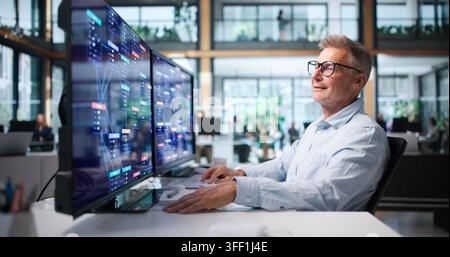 Business Analyst Reviews Low Code Platform Workflow On Desktop Computer. Stock Photo