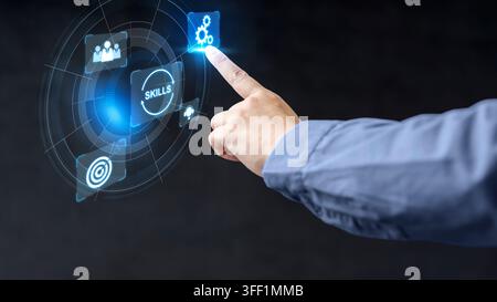 A close-up of a professional person interacting with a futuristic, holographic digital user interface displaying icons for skill development and techn Stock Photo