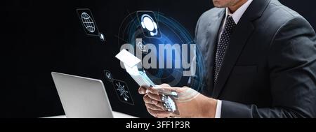 A businessman in a suit interacts with a futuristic holographic digital interface, representing concepts of global business, communication, and advanc Stock Photo