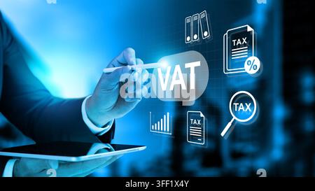 Businessman using a tablet and stylus to manage Value Added Tax (VAT) with virtual tax icons on a digital interface. Concept of house and property tax Stock Photo