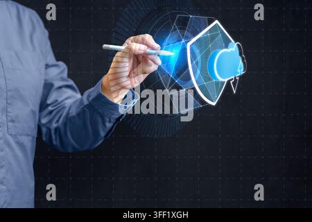 Businessman using stylus to interact with futuristic digital interface representing cloud computing security, featuring a glowing shield and cloud ico Stock Photo