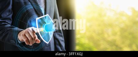 Businessman interacting with a holographic shield and cloud icon, representing cloud security and data protection. Secure cloud storage concept Stock Photo