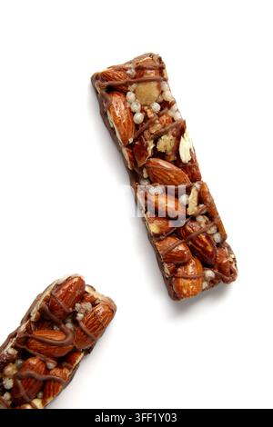 Two sweet caramel chocolate bars with nuts isolated on white background. Top view with copy space Stock Photo
