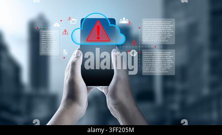 Hands holding a smartphone showing a cloud storage security warning and cyber threat digital graphics over a blurred city background. Cloud computing Stock Photo