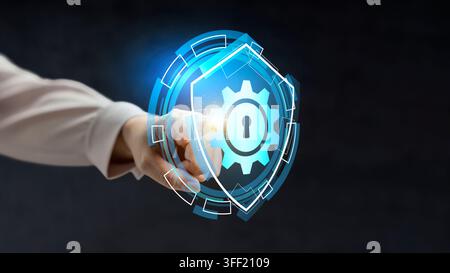A businesswoman pointing at a glowing digital gear icon with a keyhole, symbolizing cyber security, system protection, and technological automation. C Stock Photo