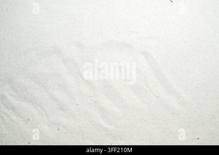 White fine sand texture background with subtle ripple patterns. Clean minimalist natural surface. Summer, natural or texture background Stock Photo