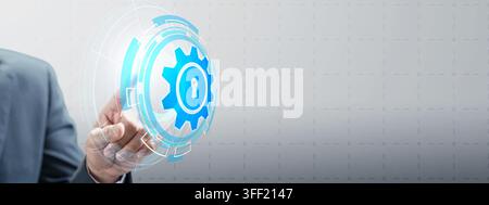 A businessman pointing at a glowing digital gear icon with a keyhole, symbolizing cyber security, system protection, and technological automation. Con Stock Photo