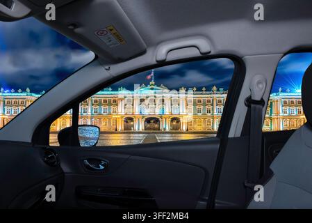 View of the grand Hermitage Museum in St. Petersburg, Russia, illuminated at night, seen through a car's windshield. Stock Photo