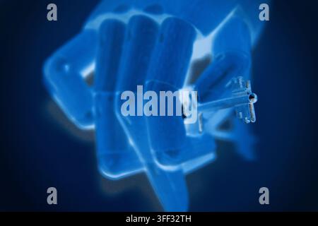 Close-up of a robotic hand holding a metal key, representing artificial intelligence, digital security, access control, technological innovation, auto Stock Photo