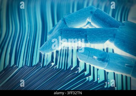 Close-up of a robotic hand selecting one sheet of paper from several documents, symbolizing artificial intelligence, automation, decision making, info Stock Photo