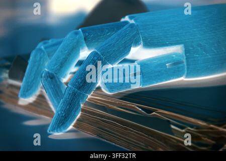 Close-up of a robotic hand among sheets of paper on an office desk, representing artificial intelligence, document management, automation, information Stock Photo
