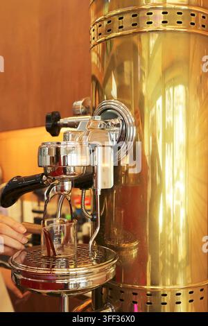 Close-up of a barista making fresh espresso using a vintage manual lever coffee machine Stock Photo