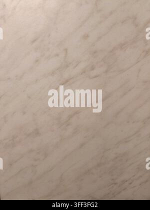 Muted cream and beige marble texture creating a subtle backdrop with diagonal veins, perfect for elegant design elements and architectural backgrounds Stock Photo
