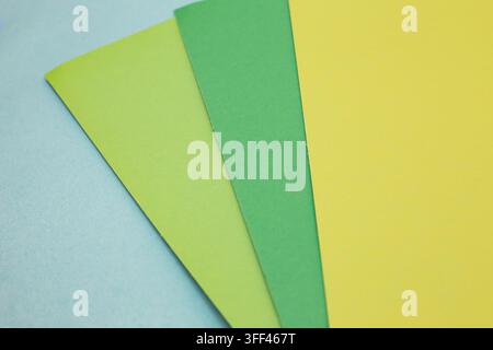 sheets of colored paper. Many colored sheets of paper are laid out in the harsh composition. background of colored paper. place for text. view from th Stock Photo