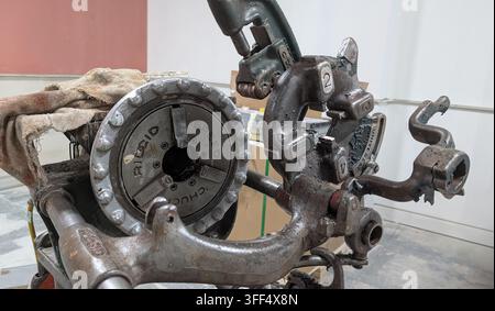 London, UK - August 26, 2026: Close-up of a used Ridgid pipe threading machine with metal die head and cutting mechanism inside an industrial workshop Stock Photo