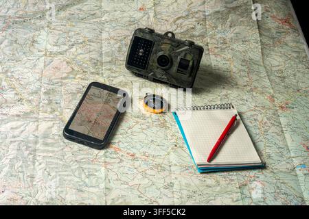 Planning an outdoor adventure using map and technology Stock Photo