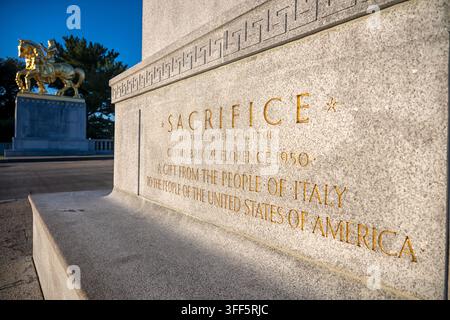 Sacrifice Statue Inscription on Arlington Memorial Bridge | WASHINGTON, D.C. — An inscription reading "Sacrifice" and "A Gift From the People of Italy to the People of the United States" is carved into the pedestal of a gilded-bronze statue on Arlington Memorial Bridge, Sunday, Sept. 6, 2026. Sculptor Leo Friedlander modeled the Sacrifice group, cast in bronze in Florence in 1950. The matching Valor statue is visible in the background atop its own pedestal. Stock Photo
