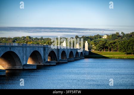 Arlington Memorial Bridge over the Potomac River in Washington DC | WASHINGTON, D.C. — Arlington Memorial Bridge spans the Potomac River toward Arlington House and Arlington National Cemetery, Sunday, Sept. 6, 2026. McKim, Mead and White designed the Neoclassical bridge, built 1926-1932, on a sightline linking the Lincoln Memorial to Arlington House. Nine arches of white granite-faced concrete carry the roadway roughly 2,138 feet (652 m) between termini. A 2018-2020 rehabilitation replaced its obsolete drawbridge span with a fixed one. Stock Photo