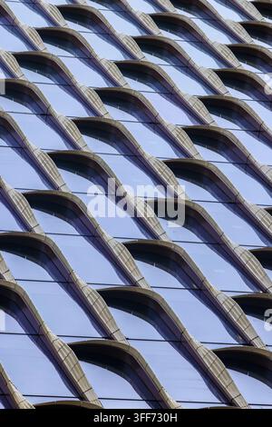 A modern architectural design featuring ridges of fins, creating a rhythmic pattern across the building exterior. Stock Photo