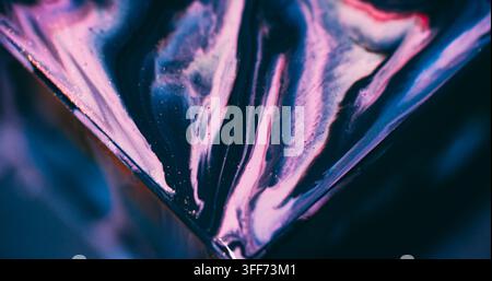 Sparkling fluid. Ink spill. Defocused blue purple pink color glitter triangle mix acrylic texture floating on abstract art background. Stock Photo