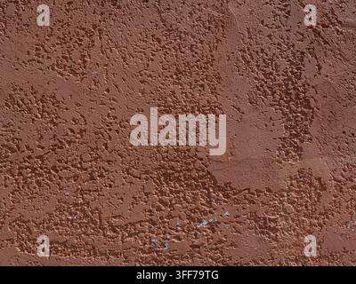 Old worn dark pink stucco or cement wall for use as a background texture Stock Photo
