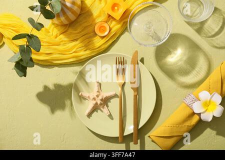 Summer dining and coastal lifestyle, table setting with starfish and tropical flowers for a beach vacation or seaside restaurant dinner Stock Photo
