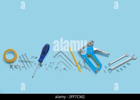 Carpenters tools with screws on blue background Stock Photo