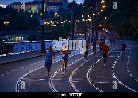 Runners spread out along the Vltava riverfront during the RunCzech 10 km evening road race in Prague Stock Photo