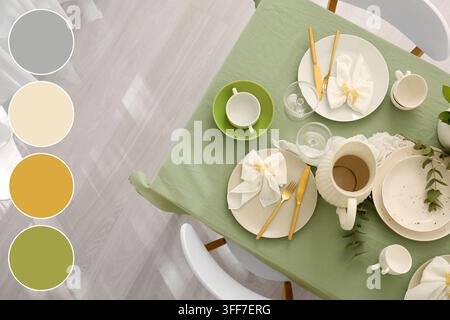 Table setting and hospitality, elegant dining room decor with green tablecloth and ceramic plates for home interior design and festive event planning Stock Photo