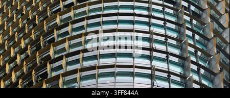 Panoramic background of a modern skyscraper facade with repeating external louvers. Stock Photo