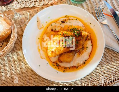 Delicious fried cod with creamy white beans and gravy Stock Photo