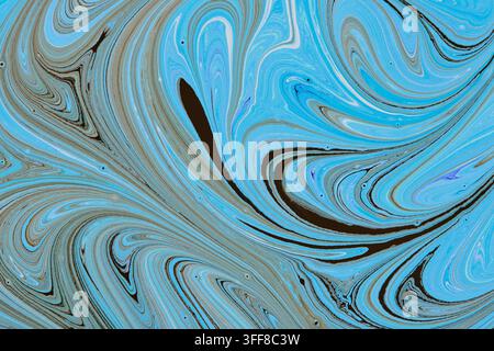 Dynamic blue and dark fluid paint marble swirl pattern creating an elegant abstract background Stock Photo