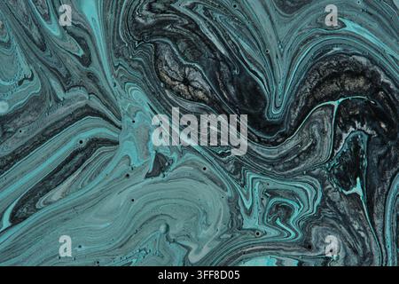 Close up liquid marble acrylic texture with dark black and turquoise blue fluid swirl patterns Stock Photo