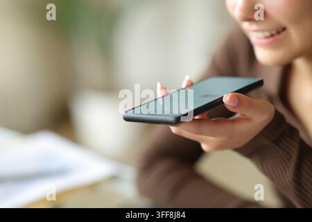 Close up portrait of a happy office worker using ai on phone using voice recognition Stock Photo