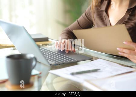 Close up portrait of an office worker hands working online holding documents Stock Photo